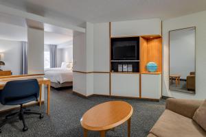 a hotel room with a bed and a desk and a couch at Fairfield Inn & Suites by Marriott Lawton in Lawton