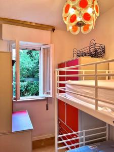 a room with a window and a shelf with towels at Beach house with private garden and parking in Grado-Pineta