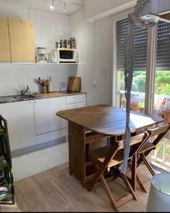 a kitchen with a wooden table in a kitchen at Studio 27 m2 avec terrasse 20m2 in Six-Fours-les-Plages