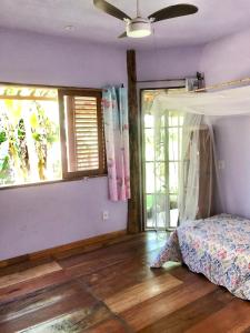 Ένα ή περισσότερα κρεβάτια σε δωμάτιο στο Vila dos Jasmins Casa