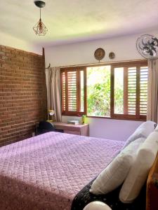 Ένα ή περισσότερα κρεβάτια σε δωμάτιο στο Vila dos Jasmins Casa