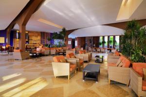 a hotel lobby with couches and tables and chairs at Retac Qunay Dahab Resort & SPA in Dahab