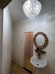 a bathroom with a sink and a mirror at Csaky Palace Bratislava in Bratislava