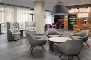 a waiting area with chairs and a table in a hospital at Courtyard Portland East in Portland