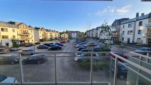 a view of a parking lot with cars parked at Robert's New studio apartment Łódź Widzew in Łódź