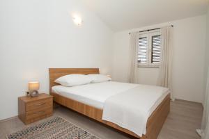 Postel nebo postele na pokoji v ubytování Apartman Francesca