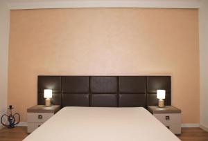 a bedroom with a large bed with two night stands at Studio Dristor - foarte curat si frumos in Bucharest
