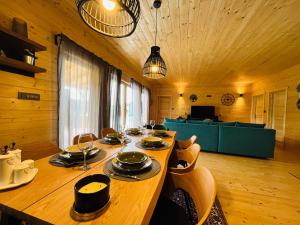 a dining room with a long wooden table with chairs at Holiday House Marin in Selno