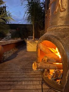 a stone oven with a fire inside of it at PAZ Y ARMONÍA en chuy 2 in Chuy
