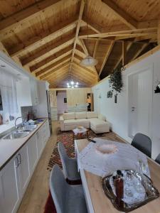 a kitchen and living room with a table and a couch at Xhumba Guesthouse 