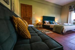 a living room with a couch and a bed at The Village House in Volos