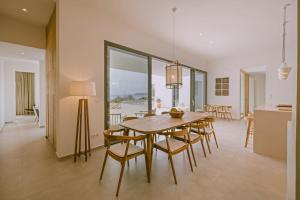 a kitchen and dining room with a table and chairs at Lemon Hill Villa / Landmark Hosting in Finikounta