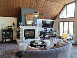 a living room with a couch and a fireplace at Otter Creek Eau Claire Altoona in Altoona