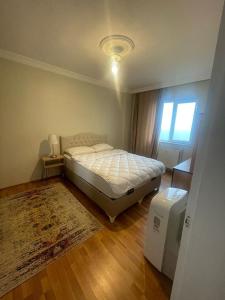 a bedroom with a bed and a window and a rug at Paradice App in Istanbul