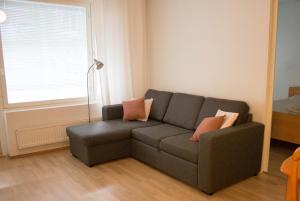 a living room with a couch and a window at Lahti Center House in Lahti