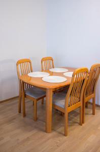 a wooden table with four chairs around it at Lahti Center House in Lahti