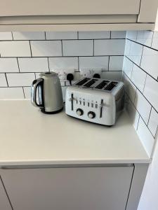 a kitchen counter with a stove and a tea kettle at Arlos in Blackpool