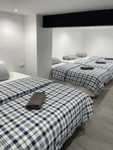three beds in a room with at Downtown Apartments in Alicante