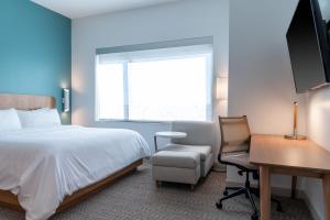 a hotel room with a bed and a desk and a window at Element by Marriott Dallas Richardson in Richardson +35 photos