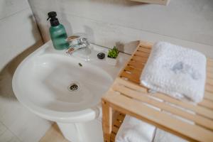 a bathroom sink with a soap bottle on top of it at Domki na Górniej Łące - Dwa Wróble in Łazany