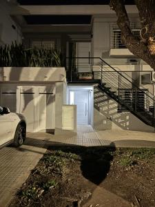 a white car parked in front of a garage at CASA TEOS in San Lorenzo