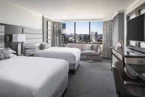 a hotel room with two beds and a television at The Ritz-Carlton Atlanta in Atlanta