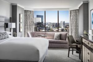 a hotel room with a bed and a couch at The Ritz-Carlton Atlanta in Atlanta