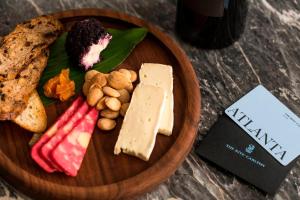a wooden plate with different types of cheese and nuts at The Ritz-Carlton Atlanta in Atlanta