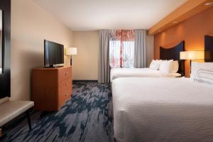 a hotel room with two beds and a flat screen tv at Fairfield Inn & Suites Redding in Redding +15 photos