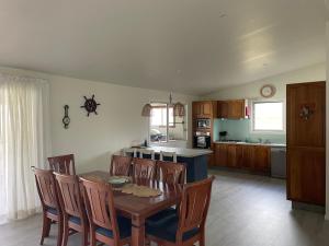 a kitchen with a table and chairs in a room at 1 Tree Escape in Wooli +21 photos