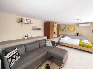 a living room with a couch and a bed at Village house with a nice garden in Stérnai