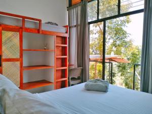 a bedroom with a bed and a large window at Las Terrazas de Barili in Barili