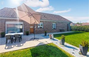 a patio with a table and an umbrella at Stunning Home In Quoux-haut-manil With Wifi And 2 Bedrooms in Haut-Maînil