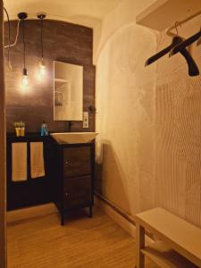 a bathroom with a sink and a ceiling fan at São Pedro Suite Faro in Faro +34 photos
