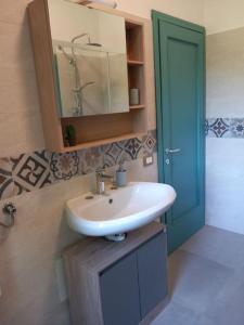 a bathroom with a sink and a blue door at Holiday house - Leo & Malù in Sarnico