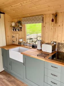 a kitchen with a sink and a counter top at The Stone Wall Hideaway in Portglenone