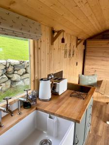 a kitchen with a sink and a counter top at The Stone Wall Hideaway in Portglenone