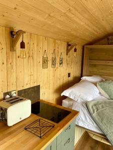 a bedroom with two beds and a counter with a toaster at The Stone Wall Hideaway in Portglenone