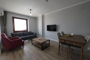 a living room with a couch and a table at Royal Homes 405 in Antalya