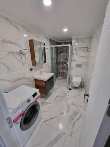a white bathroom with a washing machine in it at Royal Homes 405 in Antalya