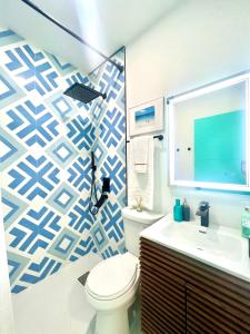 a bathroom with a toilet and a sink at SOBE MONARCH-WALK TO THE BEACH - OCEAN DRIVE GOOD TIME HOTEL AND ANGLER HOTEL ACROSS THE STREET in Miami Beach