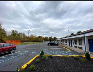 a car parked in a parking lot next to a building at DELUXE INN in Erie