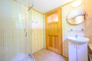 a bathroom with a shower and a sink and a toilet at Domki nad morzem Nevadas in Darłowo +24 photos