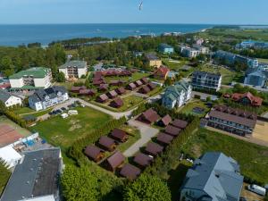an aerial view of a town with houses and the ocean at Domki nad morzem Nevadas in Darłowo