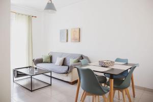 a living room with a couch and a table at Mimis Villa in Igoumenitsa
