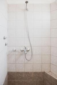 a shower with a hose in a bathroom at Mimis Villa in Igoumenitsa