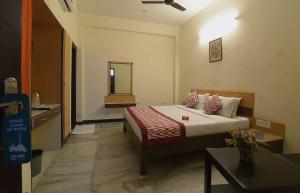 a hotel room with a bed and a mirror at Hotel Kathir Palace in Madurai