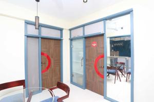 a room with sliding glass doors and a dining room at Hotel Vastukar Retreat in Bhubaneshwar
