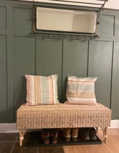 a bench in a room with pillows on it at Tantallon Guest Room with Private Beach in French Village