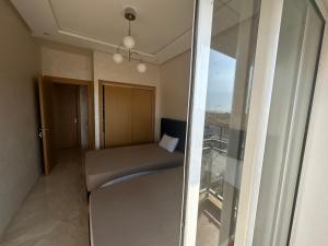 a room with a bed and a glass window at Casa bay sidi rahal in Sidi Rahal +18 photos